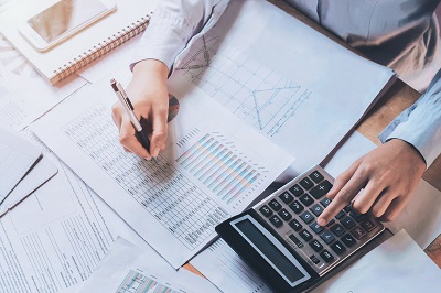 businessman working on budget using calculator