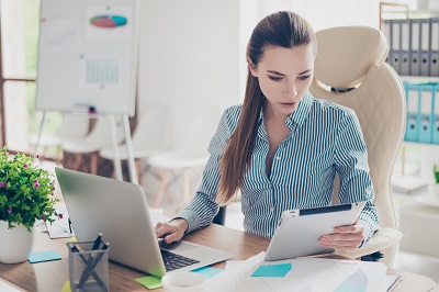 young accountant working with laptop and financial documents