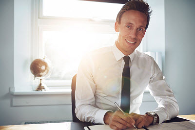 businessman writing on his notebook in his office